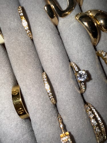 Customer's Petite Zirconia Ring collection in a grey velvet jewelry organizer