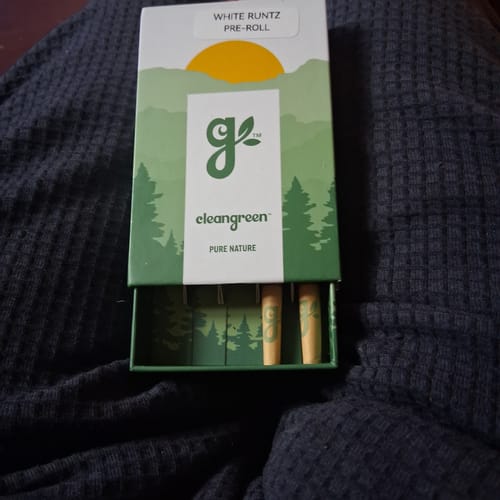 Customer's White Runtz Pre-Roll green box showing two pre-rolls inside, resting on a textured dark fabric.