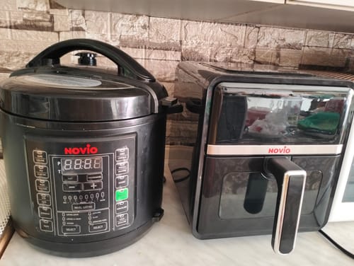 Customer's Air Fryer Novio StonePro sitting on a kitchen counter next to a black electric pressure cooker.