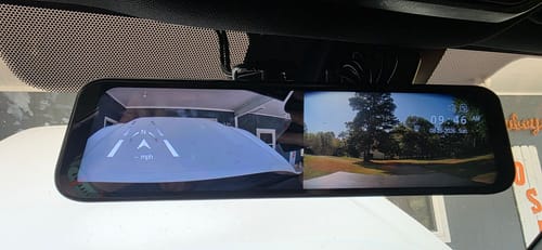 Customer's WOLFBOX G840S dash cam mounted to a rearview mirror, displaying a digital rear view and date on screen.