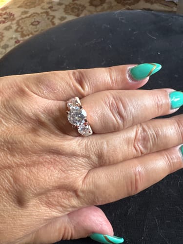 Reviewer's hand wearing a Rinfit Silicone Ring with three clear, round stones on a finger.