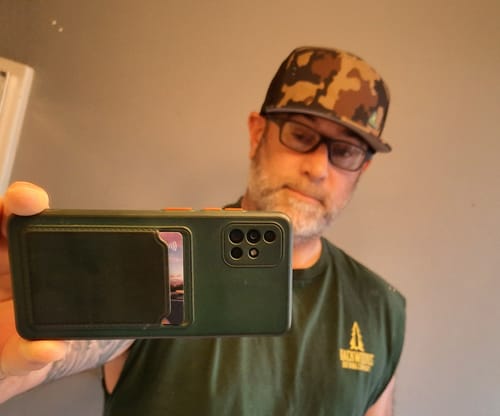 Customer's Big Flat Bill Structured Watersport Hat in a camo print worn by a person