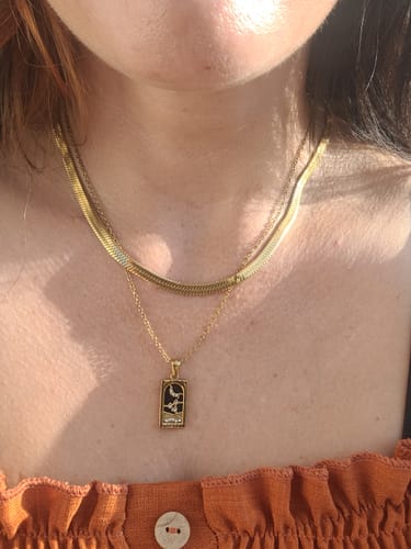 Customer's layered gold necklaces from the Waterproof Jewelry Bundle worn on the neck.