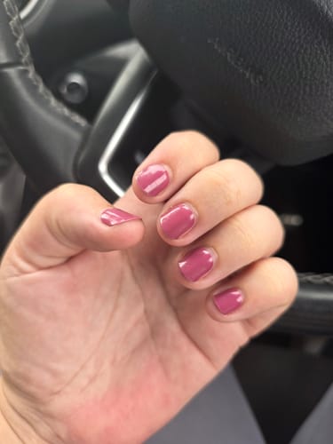 Customer's hand showing smooth, mauve Holy Gels nails after one week of wear while in a car.