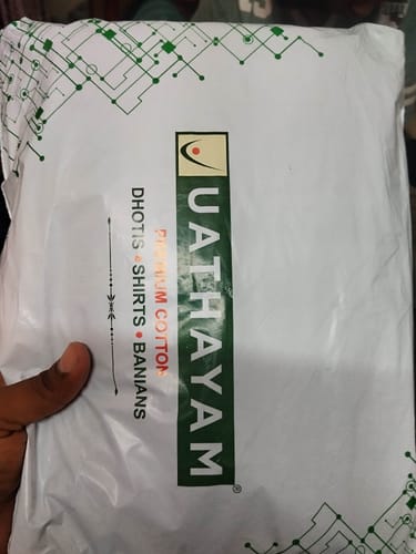 Customer's packaging for Double Delight White Shirts showing the Uathayam brand logo and product details.