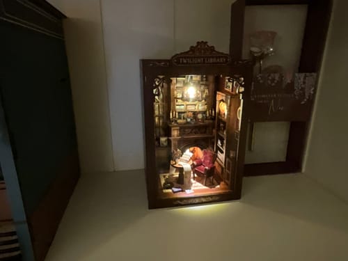 Customer's assembled Twilight Library kit lit with warm light, showcasing a gothic reading room setting.