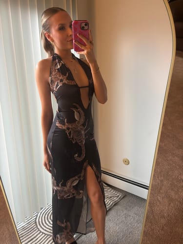 Customer's black backless y2k dress with graphic scorpion pattern, worn with a deep V-neckline in a mirror selfie.