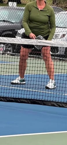 Customer's CUURT Muuv court shoes while playing pickleball on an outdoor blue court.
