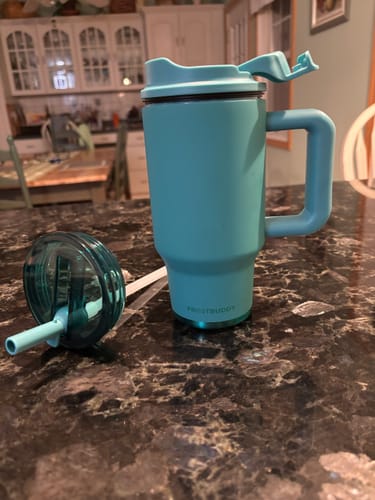 Customer's Tidal Teal Thicc Buddy mug and lid on a dark granite countertop.
