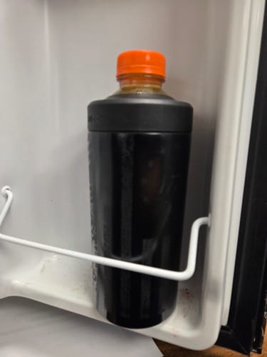 Customer's Universal XL holder with a drink bottle stored inside a refrigerator door shelf.