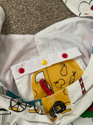 Customer's Prym Snaps Press Fasteners, featuring red and yellow plastic snaps attached to an inside purse pocket.