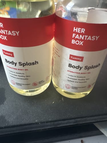 Customer's two bottles of Yummy Body Splash standing side by side on a surface.