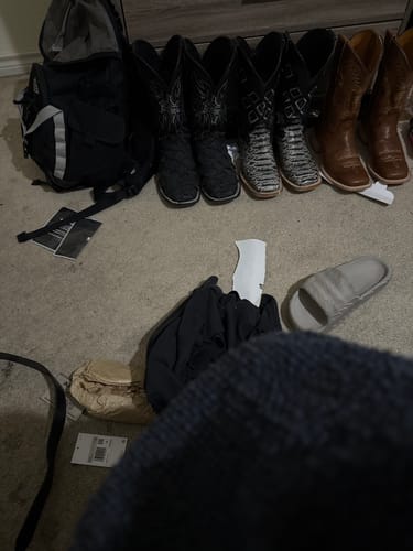 Customer's Tan Genuine Leather Boots with square toes and several other pairs of boots lined up on the floor.