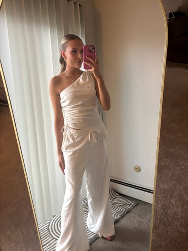 Reviewer in mirror selfie wearing the Ivory Sorrento Linen Wide-Leg Pant and matching one-shoulder top.