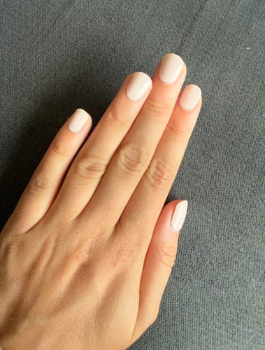Reviewer's hand showing natural babyrosa UV Gel Nail Wraps from the Elegant Perfection collection.