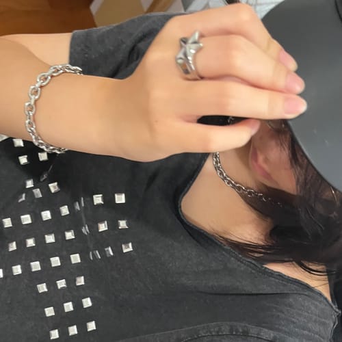 Customer's silver Aries Bracelet worn on a wrist, paired with a matching chain necklace.