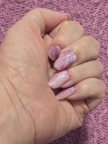 Customer's hand showing long, glittery purple Berry Milkshake gel nails.