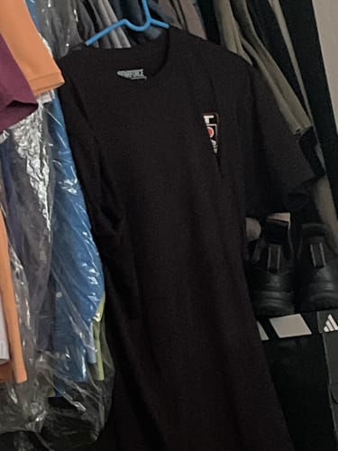 Customer's black Legendary GTR Tee hanging on a hanger in a closet.