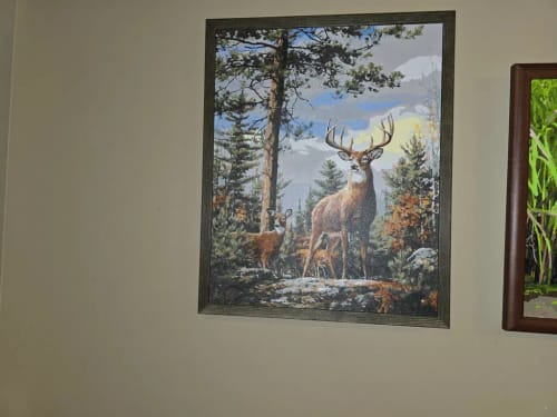 Customer's Custom Paint By Numbers forest scene featuring a stag and fawn, displayed in a frame on a wall.
