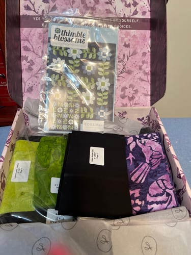 Customer's Edelweiss Quilt Kit, showing the fabric pieces and pattern inside the open branded box.