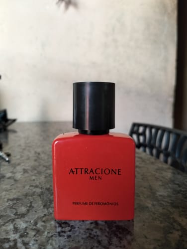 Customer's Attracione Men perfume bottle, red, square, on a surface.