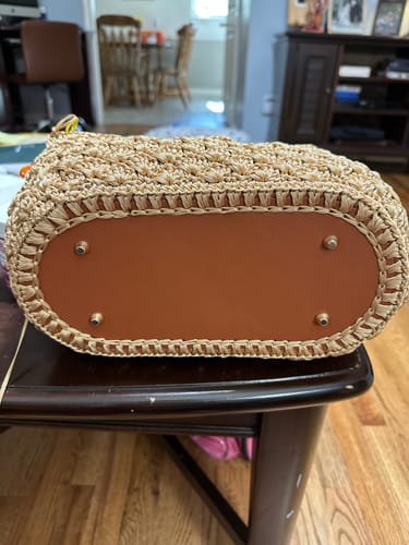 Customer's Aveline Crochet Shoulder Bag base showing the tan leather bottom and silver metal feet.