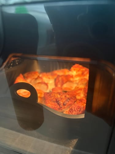 Customer's Novio StonePro air fryer with a clear window showing cooked food inside.