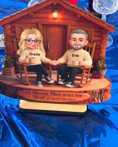 Customer's Eternal Love Couple Wooden Plaque on a blue party table, personalized with names Sheila and Rob.