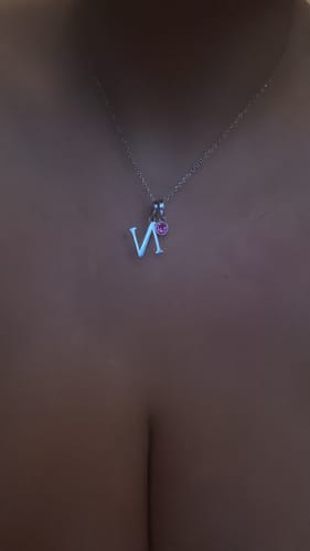 Customer's Birthstone Initial Necklace featuring a letter N pendant and a small pink birthstone on a delicate chain.