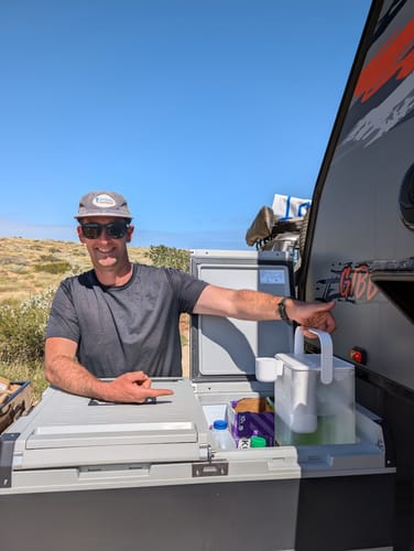 Customer with the HydroX in their caravan on the Ningaloo coast