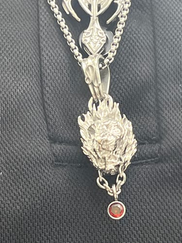 Customer's Leo Zodiac Pendant featuring a lion skull design with flames and a red gem detail on a silver chain.
