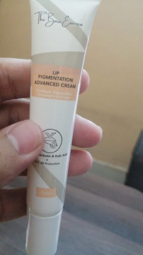 Customer's hand holding a tube of Advance Lip Pigmentation Cream, showcasing the branded packaging and label details.