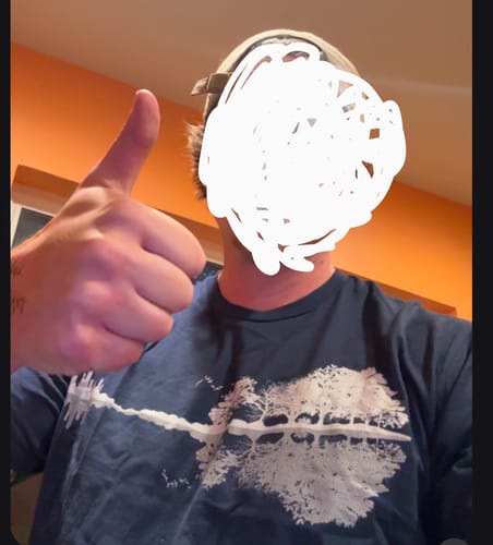 Customer's dark blue Forest Guitar T-Shirt worn by a person giving a thumbs up gesture.