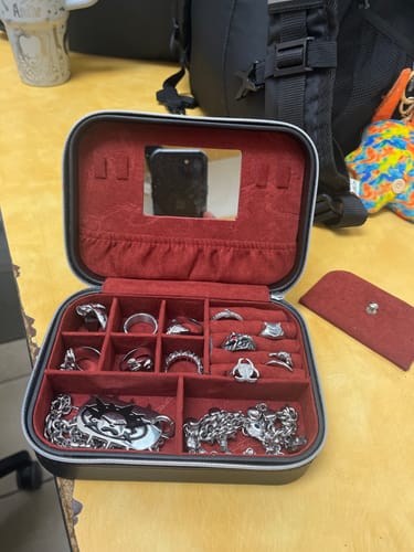 Customer's open DYT Travel Jewelry Case with red velvet interior, holding silver chains and rings