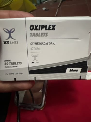 Customer's Oxiplex 50mg tablets box held by a hand.