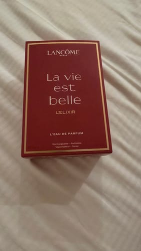 Customer's Lancome La Vie est Belle L'Elixir perfume box in deep red with gold details on a textured surface