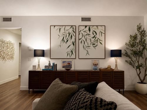 Customer's Graceful Leaves set of 2 wall art prints hanging above a sideboard in a living room.