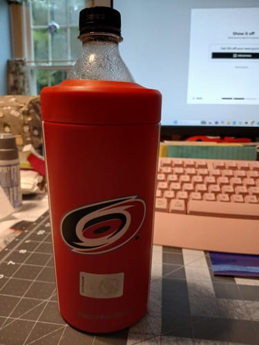 Customer's red Carolina Hurricanes Universal XL drink holder on a desk holding a plastic soda bottle.