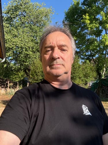 Customer's black COLLECTION MC QUEEN t-shirt with a white graphic on the chest, worn outdoors in a sunny setting.