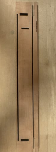 Customer's apple wood board cut by Lightburn Software, featuring straight lines and rectangular slots.