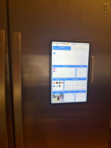 Customer's Everblog FridgeCal calendar mounted on a stainless steel refrigerator showing a digital daily schedule.