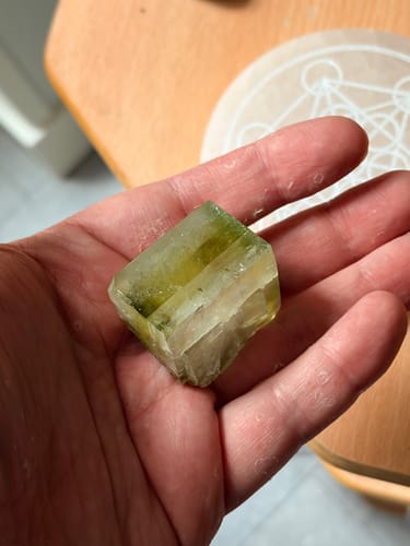 Customer's natural green Apophyllite Verte crystal held in the palm of a hand.
