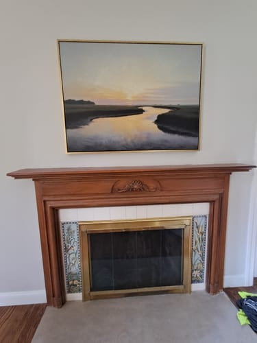 Customer's Tidal Whispers canvas art mounted above a traditional wood fireplace.