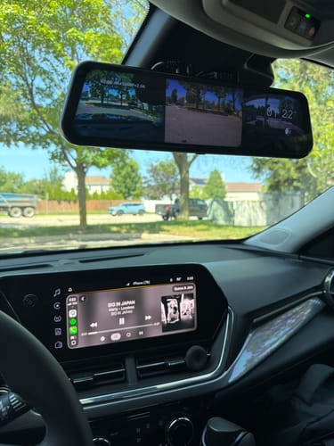 Customer's WOLFBOX G900TriPro rearview mirror camera installed in a car, displaying a triple screen view of the road.