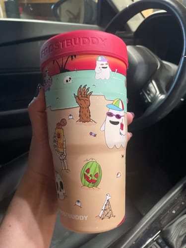 Customer's To-Go Buddy cup featuring a festive beach scene with cartoon ghosts and pumpkins, held in a hand.