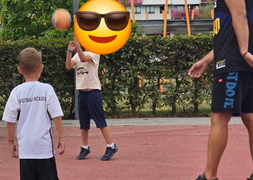Customer's child wearing dark Kinder Active II Pro barefoot shoes while playing with a ball on an outdoor court.