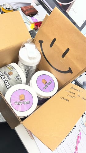 Customer's UGLYFACE AMINOS+ containers, a shaker bottle, and a handwritten welcome note inside an open cardboard box.