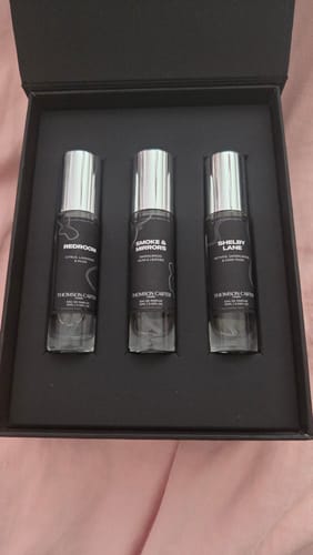 Customer's Redroom Eau de Parfum trio set containing three small glass fragrance bottles in a black presentation box.