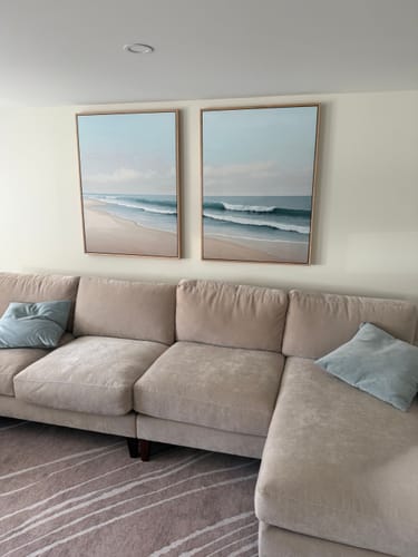 Customer's Gentle Surf Set of 2 wall art prints hung side by side above a large neutral sofa.