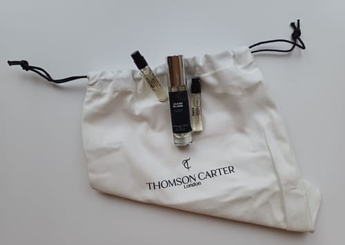 Customer's Lilium Blume perfume bottle with two sample vials on a branded white drawstring bag.